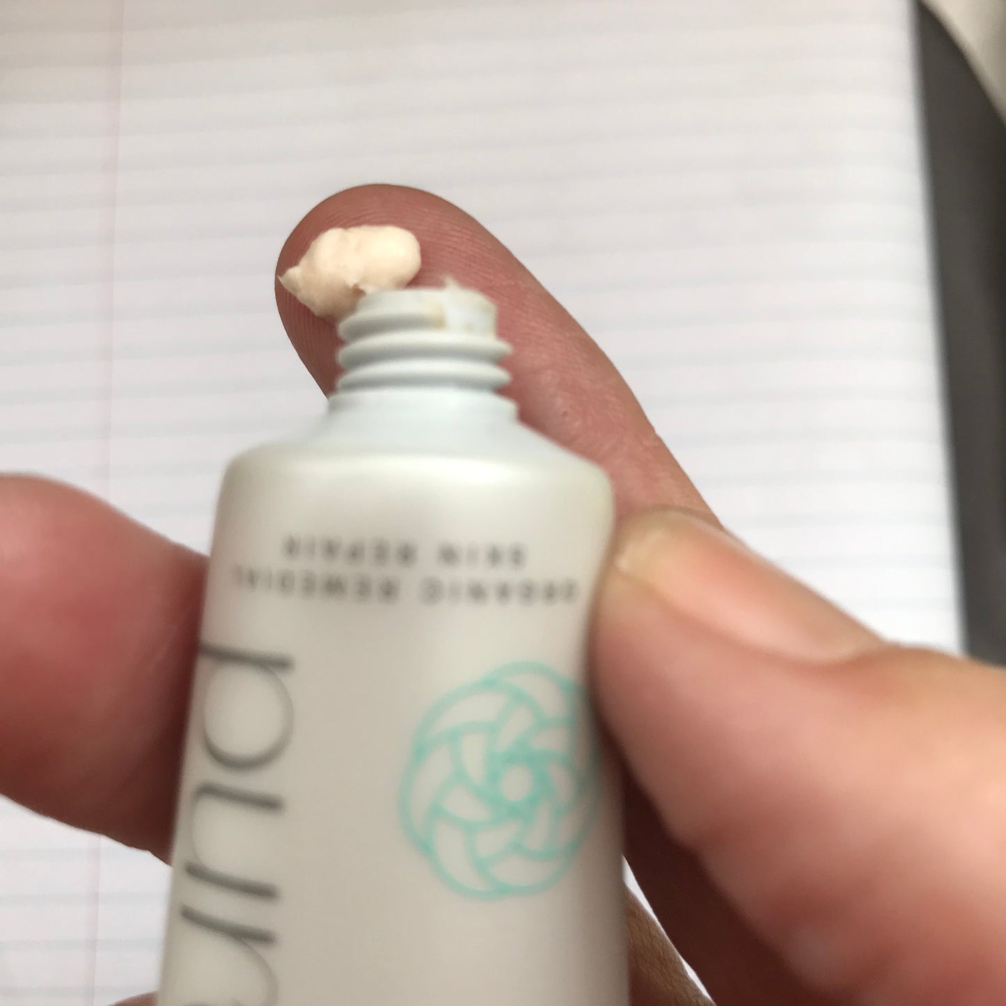 high actor natural eczema cream squeezed out of sugarcane tube onto fingertip