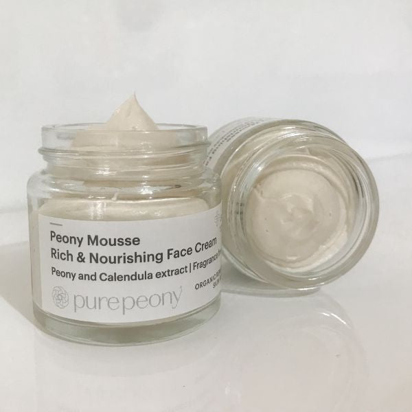 2 jars of peony mousse with lid off and facing the camera