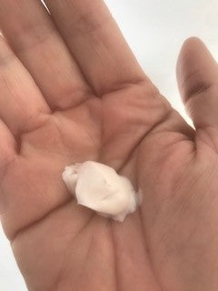 NZ made natural eczema moisturiser cream for dry itchy skin shown as a blob in cup of hand