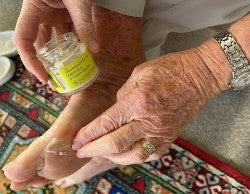 customer applying Skin Remedy for Feet to soothe and heal dry eczema prone feet