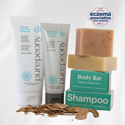 Pure Peony skincare products including cream, soap, and shampoo on a white background with Eczema Association New Zealand logo.