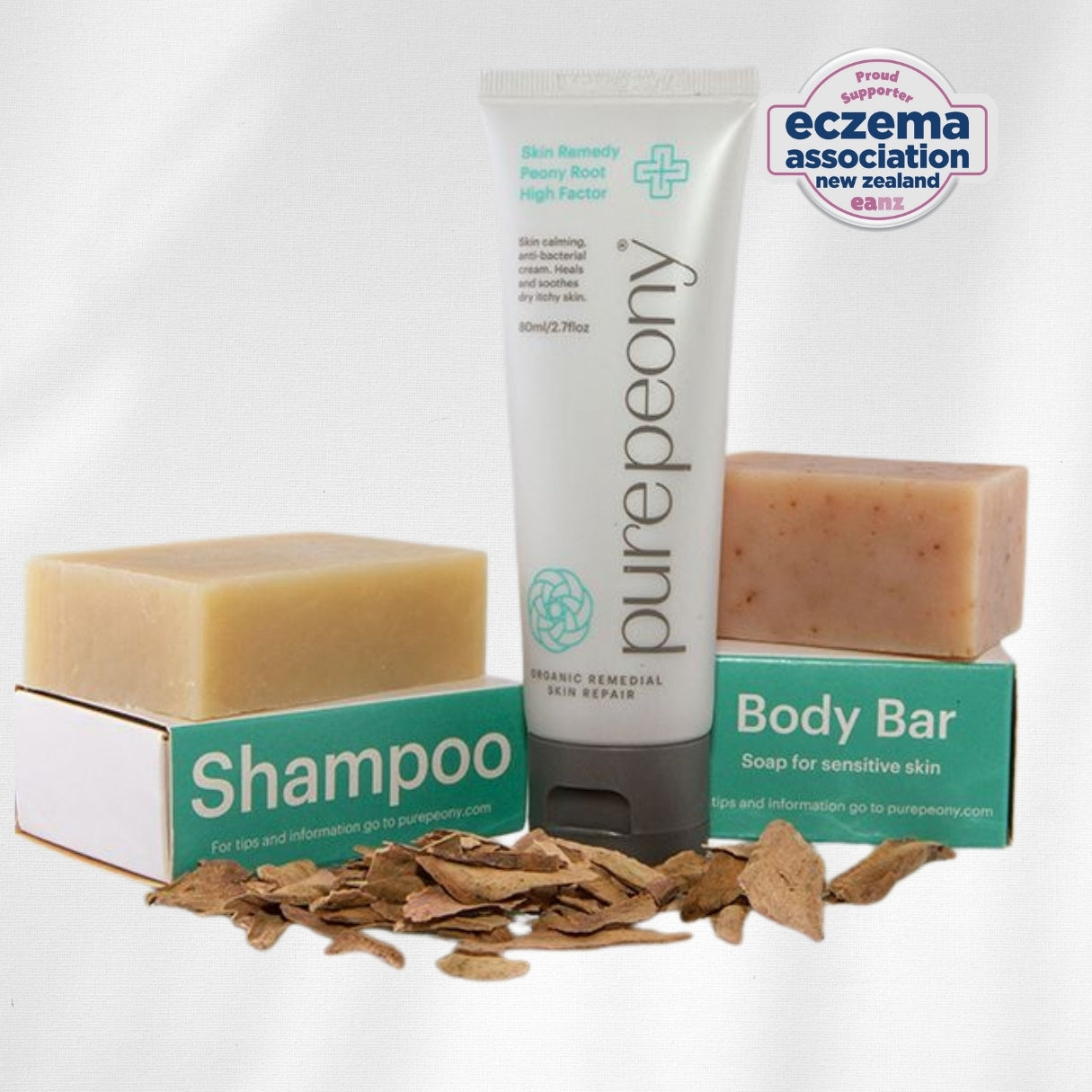 pure peony shampoo  body bar, and high factor steroid free cream approved by eczema association on a white background