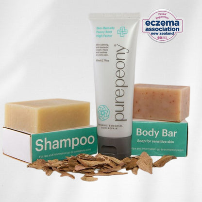 pure peony shampoo  body bar, and high factor steroid free cream approved by eczema association on a white background