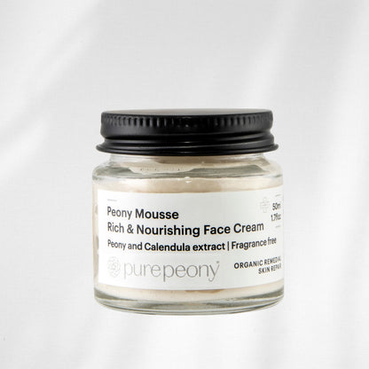Jar of Peony Mousse Rich & Nourishing Face Cream with a black lid on a white background